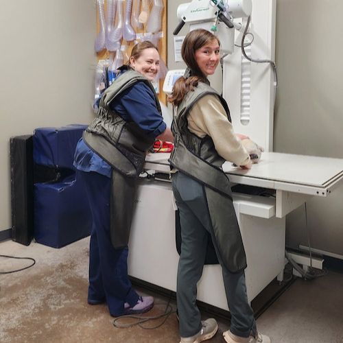 two people standing in front of a medical machine